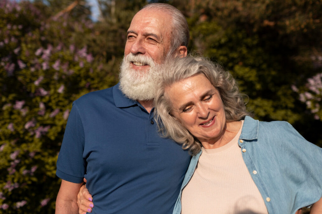 Elderly couple smiling while holding hands, symbolizing sexual satisfaction