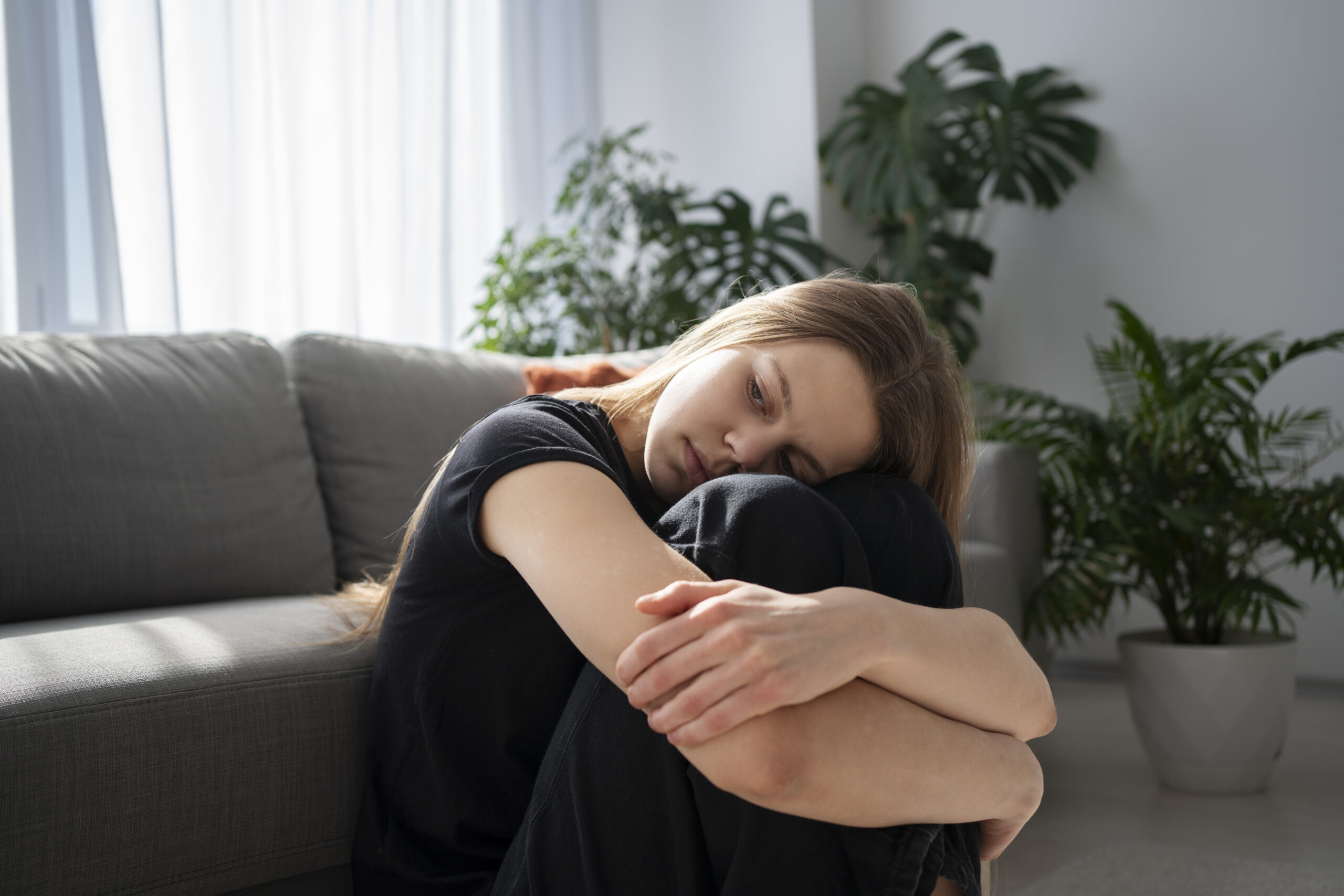 Caregiver sitting in meditation, focusing on emotional self-care